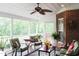 Relaxing screened porch with seating area and ceiling fan at 3331 Lazy Ln, Graham, NC 27253