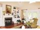 Living room with a fireplace, built-in shelving and hardwood floors at 3331 Lazy Ln, Graham, NC 27253