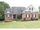 Brick home with a large front yard and landscaping at 3331 Lazy Ln, Graham, NC 27253