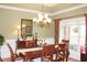 Elegant dining room, featuring a chandelier and hardwood floors at 3331 Lazy Ln, Graham, NC 27253