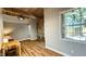 Living room with exposed brick wall and wood flooring at 1500 River Mill Drive Dr # 110, Wake Forest, NC 27587