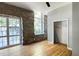 Bedroom with exposed brick wall and large window at 1500 River Mill Drive Dr # 110, Wake Forest, NC 27587