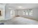 Spacious living room with carpeted floors and multiple windows at 1510 Logan St, Durham, NC 27704