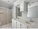 Bathroom with double vanity, a shower, and a large mirror at 1510 Logan St, Durham, NC 27704