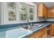 Kitchen with double sink, wood cabinets, and window at 1510 Logan St, Durham, NC 27704