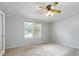 Well-lit bedroom with two windows and ceiling fan at 1510 Logan St, Durham, NC 27704