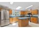 Kitchen boasts an island, stainless steel appliances, and wood cabinets at 1510 Logan St, Durham, NC 27704