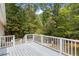 Wooden deck with white railings offering a view of the backyard at 1510 Logan St, Durham, NC 27704