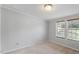Bright bedroom with neutral walls and carpet, featuring two windows at 1510 Logan St, Durham, NC 27704