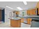 Kitchen with island, stainless steel appliances, and wood cabinets at 1510 Logan St, Durham, NC 27704