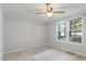 Bedroom with ceiling fan and two windows at 1510 Logan St, Durham, NC 27704