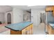 Kitchen with large island, stainless steel appliances and wood cabinets at 1510 Logan St, Durham, NC 27704