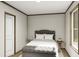 Spacious bedroom with a queen bed and bench at 369 Sombrero Ln, Henderson, NC 27537