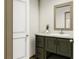 Modern bathroom with green vanity and white sink at 369 Sombrero Ln, Henderson, NC 27537