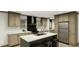 Modern kitchen with island, stainless steel appliances, and ample cabinet space at 369 Sombrero Ln, Henderson, NC 27537