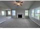 Open living room with a fireplace, high ceilings, and lots of natural light at 78 Grace Ridge Ct, Benson, NC 27504
