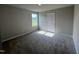 Bright bedroom with neutral walls and carpet, featuring a window and a closet at 78 Grace Ridge Ct, Benson, NC 27504