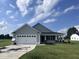 Two-car garage house with gray siding and landscaped lawn at 78 Grace Ridge Ct, Benson, NC 27504