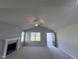 Living room with vaulted ceiling, fireplace and carpet flooring at 78 Grace Ridge Ct, Benson, NC 27504