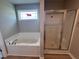 Bathroom features a soaking tub and a separate shower at 78 Grace Ridge Ct, Benson, NC 27504