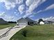 Two-car garage house with gray siding and landscaped lawn at 78 Grace Ridge Ct, Benson, NC 27504