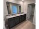 Bathroom with double vanity and a large mirror, adjacent to a walk-in closet at 184 Grace Ridge Ct, Benson, NC 27504