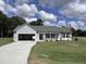 Ranch-style home with attached garage and landscaped lawn at 184 Grace Ridge Ct, Benson, NC 27504