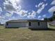 Gray siding house with a small patio and grassy backyard at 184 Grace Ridge Ct, Benson, NC 27504