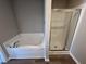 Bathroom with corner soaking tub and glass shower at 161 Grace Ridge Ct, Benson, NC 27504