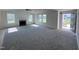 Spacious living room with fireplace, neutral carpet, and lots of natural light at 117 Grace Ridge Ct, Benson, NC 27504