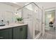 Bathroom with green vanity, frameless shower, and patterned floor tile at 226 Beacon Dr, Pittsboro, NC 27312