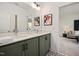 Double vanity bathroom with green cabinets and a view into a living area at 226 Beacon Dr, Pittsboro, NC 27312