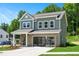 Two-story home with gray siding, brick accents, and a two-car garage at 226 Beacon Dr, Pittsboro, NC 27312