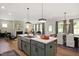 Open concept kitchen with island, stainless steel appliances, and seating at 226 Beacon Dr, Pittsboro, NC 27312