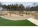 Community playground with natural wood features and soft surface at 226 Beacon Dr, Pittsboro, NC 27312