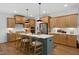 Modern kitchen with light wood cabinets, a large island, and pendant lighting at 226 Beacon Dr, Pittsboro, NC 27312