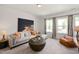 Spacious living room with sectional sofa, wood coffee table, and large artwork at 226 Beacon Dr, Pittsboro, NC 27312