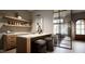Modern wet bar with marble countertop and wooden cabinetry at 5428 Winding View Ln, Raleigh, NC 27615