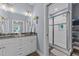 Bathroom with double vanity, large shower, and linen shelving at 13671 Burgess Rd, Middlesex, NC 27557
