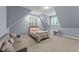 Bright bedroom featuring a cozy bed and sitting area at 13671 Burgess Rd, Middlesex, NC 27557
