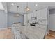 Modern kitchen with white cabinets, granite countertops and a large island at 13671 Burgess Rd, Middlesex, NC 27557