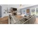 Spacious living room showcasing a stone fireplace, built-in shelving, and a large sectional sofa at 13671 Burgess Rd, Middlesex, NC 27557