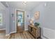 Inviting entryway with wood-look floors, a stylish console table, and a glass-paned door at 13671 Burgess Rd, Middlesex, NC 27557