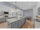 Kitchen island with granite countertop and gray cabinets at 13671 Burgess Rd, Middlesex, NC 27557