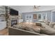 Spacious living room with stone fireplace, built-in shelving, and sliding glass doors at 13671 Burgess Rd, Middlesex, NC 27557