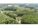 House nestled in a wooded area with a long driveway at 13671 Burgess Rd, Middlesex, NC 27557