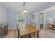 Bright dining room featuring a wood table, chandelier, and access to the front entry at 13671 Burgess Rd, Middlesex, NC 27557