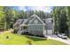 Gray two-story house with stone accents, attached garage, and large yard at 13671 Burgess Rd, Middlesex, NC 27557