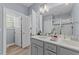 Double vanity bathroom with gray cabinets and a large mirror at 13671 Burgess Rd, Middlesex, NC 27557
