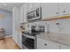 Modern kitchen with white cabinets, granite countertops, and stainless steel appliances at 13671 Burgess Rd, Middlesex, NC 27557